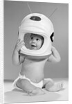 1960s Baby In Diaper Seated Holding Astronaut Helmet With Antennae On Head by Anonymous