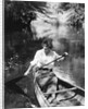 1920s Woman With Upswept Hair Paddling Wooden Canoe In Stream by Anonymous