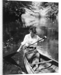 1920s Woman With Upswept Hair Paddling Wooden Canoe In Stream by Anonymous