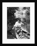 1920s Woman With Upswept Hair Paddling Wooden Canoe In Stream by Anonymous