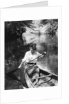 1920s Woman With Upswept Hair Paddling Wooden Canoe In Stream by Anonymous
