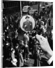 1930s 1940s Pedestrian Street Crowd Magnifying Glass Focused On Single Well Dressed Man by Anonymous