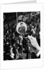 1930s 1940s Pedestrian Street Crowd Magnifying Glass Focused On Single Well Dressed Man by Anonymous