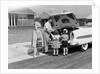 1950s Family Packing Trunk Of Car For A Picnic by Anonymous