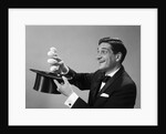 1960s Profile Magician Man Pulling 4 Eggs Out Of Hat Holding Them Between Fingers by Anonymous