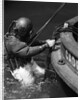 1930s Side View Of Diver In Pressure Suit Descending Into Water From Side Of Boat by Anonymous