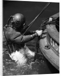 1930s Side View Of Diver In Pressure Suit Descending Into Water From Side Of Boat by Anonymous