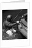 1930s Side View Of Diver In Pressure Suit Descending Into Water From Side Of Boat by Anonymous