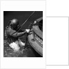1930s Side View Of Diver In Pressure Suit Descending Into Water From Side Of Boat by Anonymous