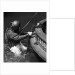 1930s Side View Of Diver In Pressure Suit Descending Into Water From Side Of Boat by Anonymous