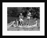 1930s Two Couples Having Summer Picnic With Food And Drink Spread Out On Blanket The Tip Of A Canoe Is Visible by Anonymous