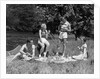1930s Two Couples Having Summer Picnic With Food And Drink Spread Out On Blanket The Tip Of A Canoe Is Visible by Anonymous