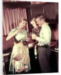 1950s Family In Kitchen Mother Pouring Milk From Pitcher For Dad And Kids by Anonymous