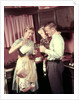 1950s Family In Kitchen Mother Pouring Milk From Pitcher For Dad And Kids by Anonymous
