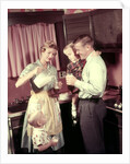 1950s Family In Kitchen Mother Pouring Milk From Pitcher For Dad And Kids by Anonymous