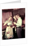 1950s Family In Kitchen Mother Pouring Milk From Pitcher For Dad And Kids by Anonymous