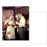 1950s Family In Kitchen Mother Pouring Milk From Pitcher For Dad And Kids by Anonymous