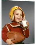 1950s 1960s Boy Drinking Glass Milk Wearing Football Helmet Shoulder Pads by Anonymous