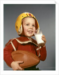 1950s 1960s Boy Drinking Glass Milk Wearing Football Helmet Shoulder Pads by Anonymous