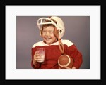 1950s 1960s Boy Drinking Milk Wearing Football Helmet Red Jersey Holding Ball by Anonymous