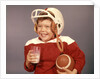 1950s 1960s Boy Drinking Milk Wearing Football Helmet Red Jersey Holding Ball by Anonymous