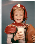1960s Boy Wearing Red Helmet Football Shoulder Pads Holding Glass Milk and Football by Anonymous