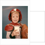 1960s Boy Wearing Red Helmet Football Shoulder Pads Holding Glass Milk and Football by Anonymous
