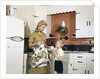 1970s Mother Handing Glass Of Milk To Son In Kitchen by Anonymous