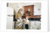 1970s Mother Handing Glass Of Milk To Son In Kitchen by Anonymous