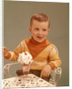 Boy Sitting At Ice Cream Parlor Table Eating Whipped Cream Cherry Topped Sundae+ by Anonymous