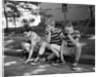 1970s Three Bored Boys Sitting On Curb All Wearing Striped Tee Shirts Shorts And Sneakers by Anonymous