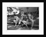 1970s Three Bored Boys Sitting On Curb All Wearing Striped Tee Shirts Shorts And Sneakers by Anonymous