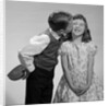 1950s 1960s Boy In Vest and Bow Tie Holding Valentine Candy Kissing Cheek Of Girl Making A Face by Anonymous