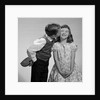 1950s 1960s Boy In Vest and Bow Tie Holding Valentine Candy Kissing Cheek Of Girl Making A Face by Anonymous