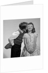 1950s 1960s Boy In Vest and Bow Tie Holding Valentine Candy Kissing Cheek Of Girl Making A Face by Anonymous