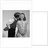 1950s 1960s Boy In Vest and Bow Tie Holding Valentine Candy Kissing Cheek Of Girl Making A Face by Anonymous