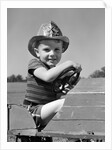 1940s Boy Playing Fireman In Toy Fire Truck Wearing Fireman's Safety Hat Holding Steering Wheel by Anonymous