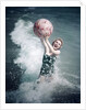 1950s Woman Jumping In Surf Holding Up Beach Ball by Anonymous