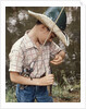 Boy Wearing Straw Hat Removing Hook From Mouth Of Fish Outdoor by Anonymous