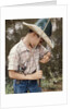 Boy Wearing Straw Hat Removing Hook From Mouth Of Fish Outdoor by Anonymous