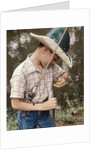 Boy Wearing Straw Hat Removing Hook From Mouth Of Fish Outdoor by Anonymous
