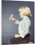1950s 1960s Girl With Pet Bird Parakeet On Her Finger by Anonymous