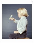 1950s 1960s Girl With Pet Bird Parakeet On Her Finger by Anonymous