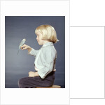 1950s 1960s Girl With Pet Bird Parakeet On Her Finger by Anonymous
