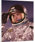 1960s Man Astronaut Lifting Up Visor Helmet Wearing Silver Navy Space Suit by Anonymous