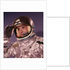 1960s Man Astronaut Lifting Up Visor Helmet Wearing Silver Navy Space Suit by Anonymous