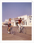 1950s Teen Couple Riding Bikes On The Boardwalk Jersey Shore by Anonymous
