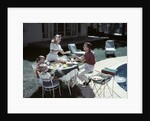 1950s Family In Backyard Having Picnic From Grill Near Swimming Pool by Anonymous
