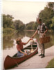 1960s Young Couple Loading Picnic Basket Thermos Into Canoe by Anonymous