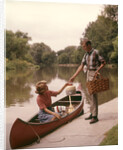1960s Young Couple Loading Picnic Basket Thermos Into Canoe by Anonymous